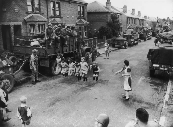 A Us Soldier Helps Some Children With Their Skipping, England, 1944