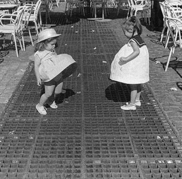 Girls Playing With Their Skirts On An Air Vent