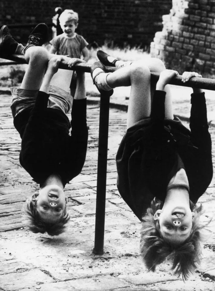 Two Children Have Great Fun Hanging Upside Down Off A Low Rail In Stockport, 1966