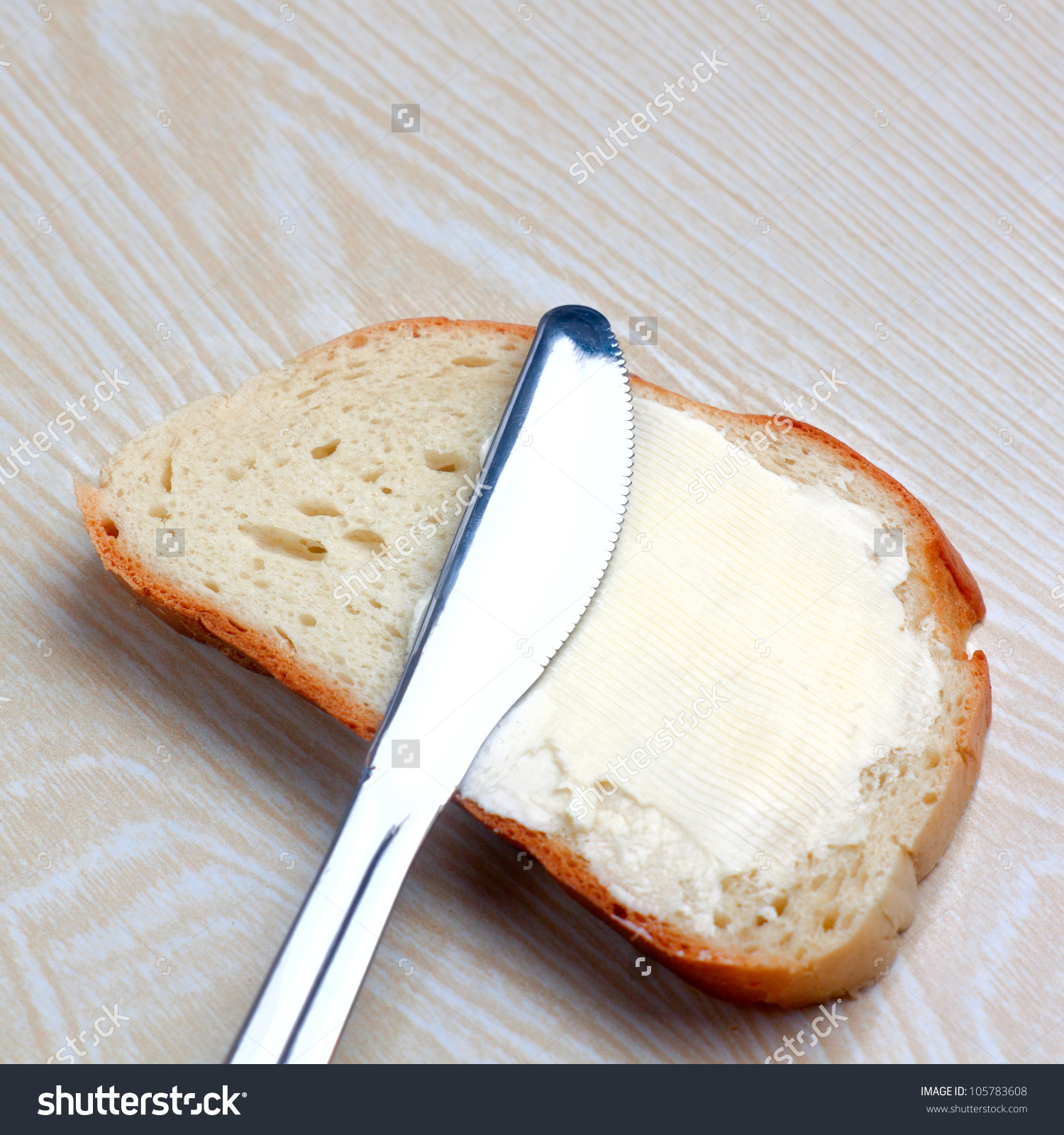 stock photo butter on a slice of bread and knife 105783608