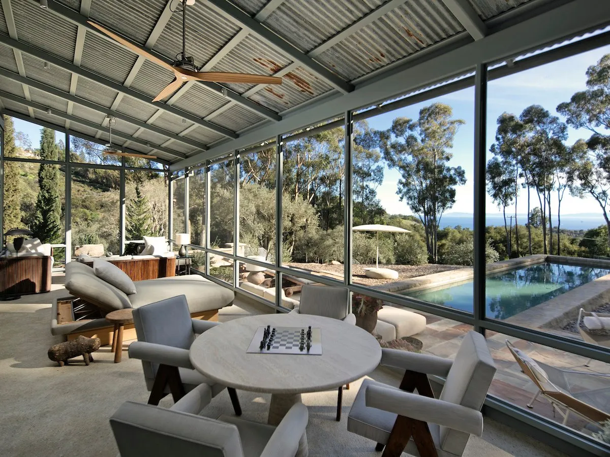 There is a sun room with a view across the pool and garden.