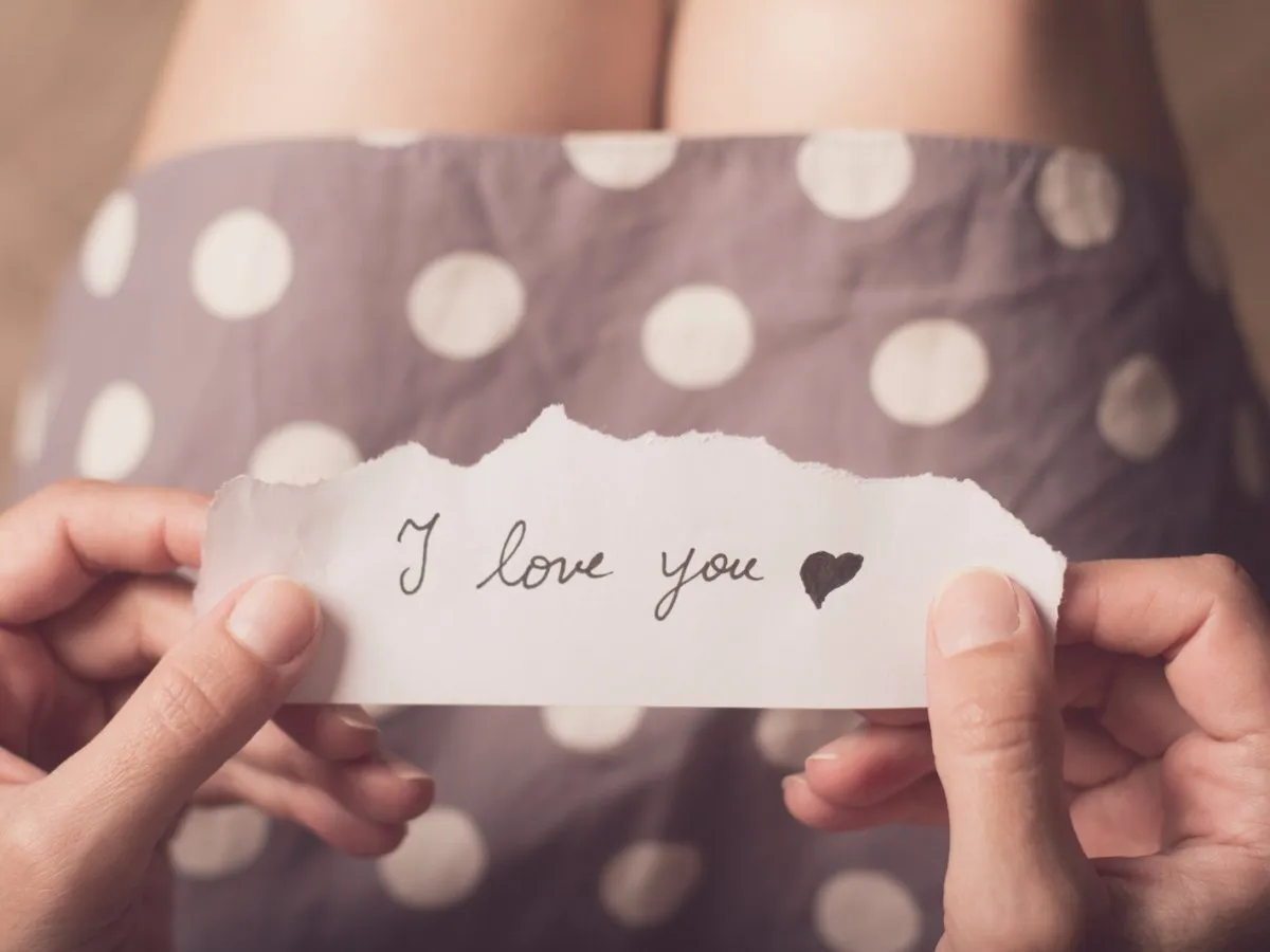 write a tiny love note on a scrap of paper and slip it in her wallet