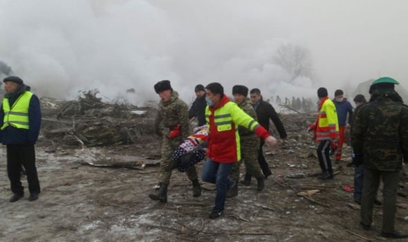 Rescue-workers-carry-a-victim-from-the-crash-site-790624