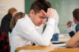 sad student sitting in a classroom BFmoxlAHs