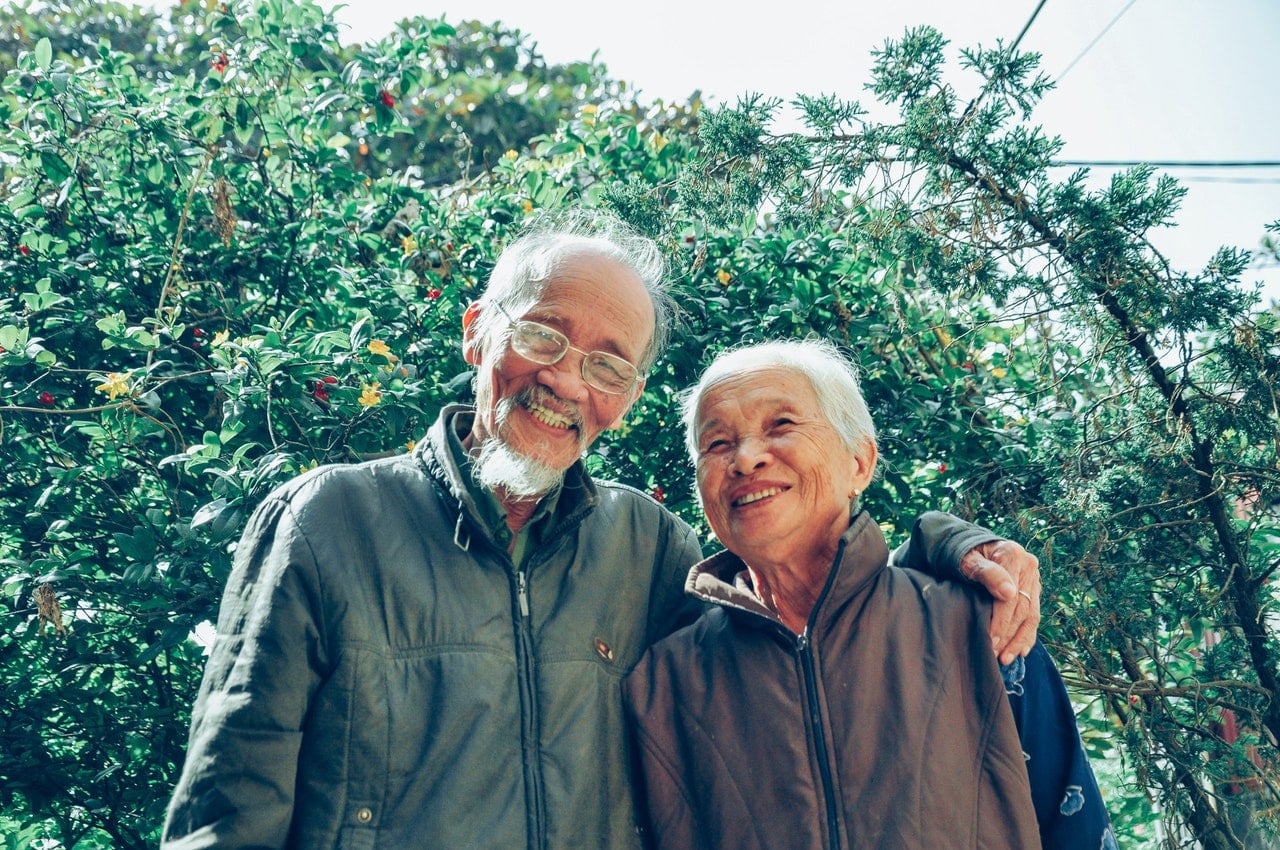 smiling man and woman wearing jackets 1642883