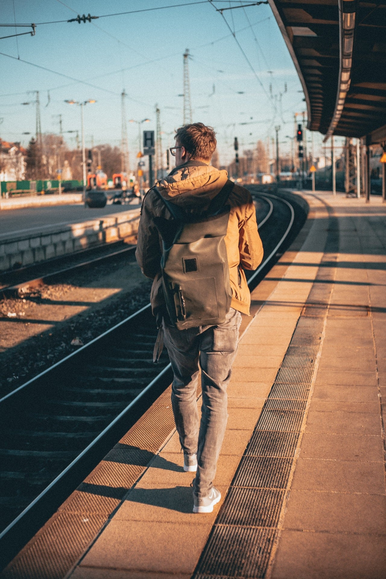 man in brown top beside railroad 2432299 image