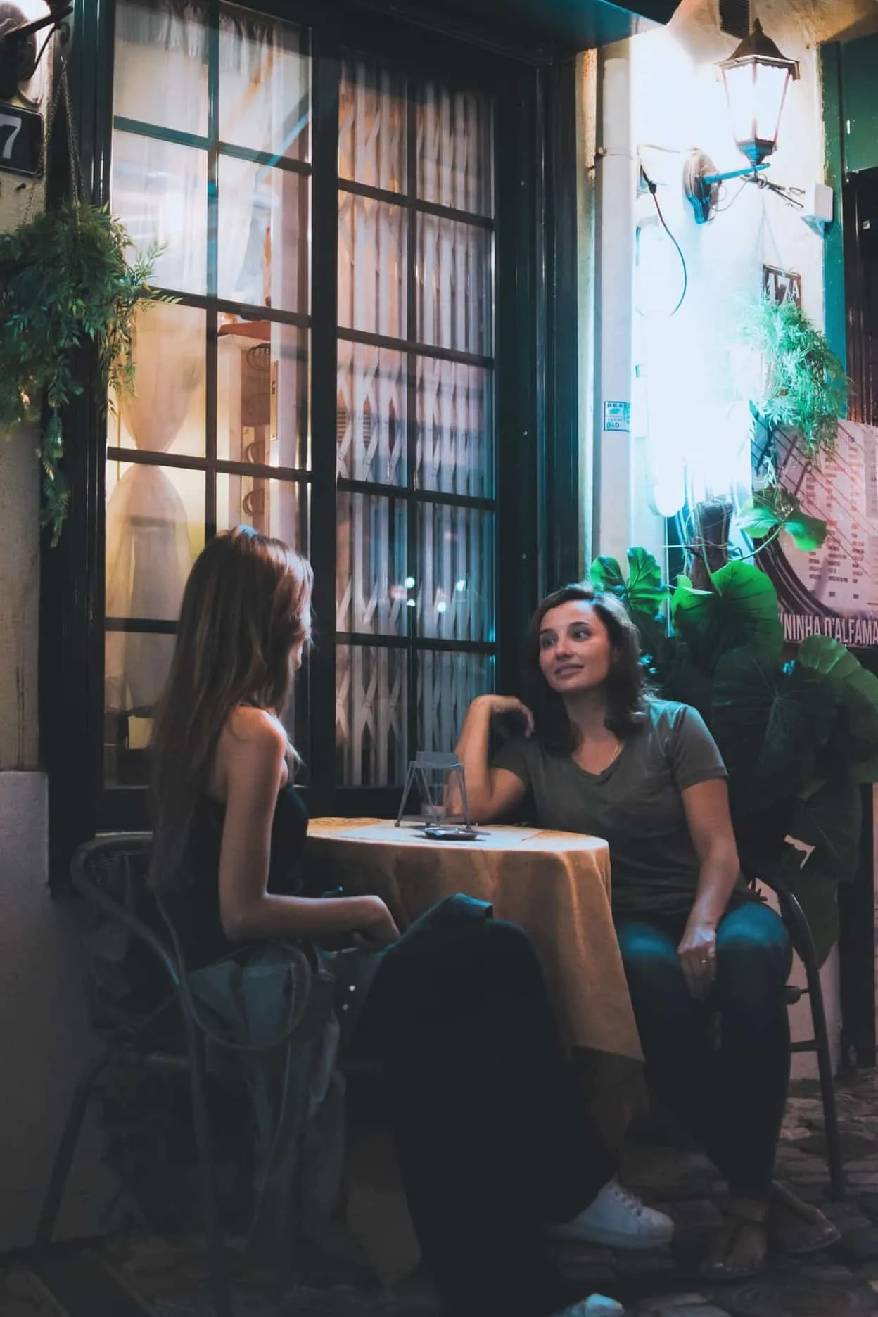 two women sitting and chatting near table 1545499 image