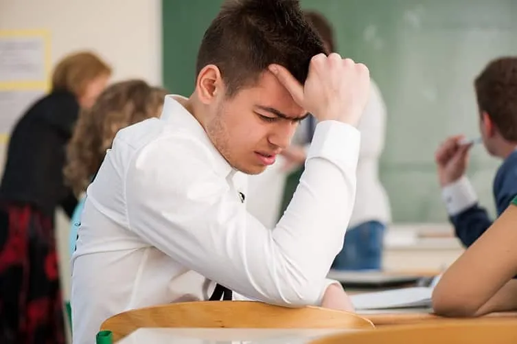 sad student sitting in a classroom BFmoxlAHs image