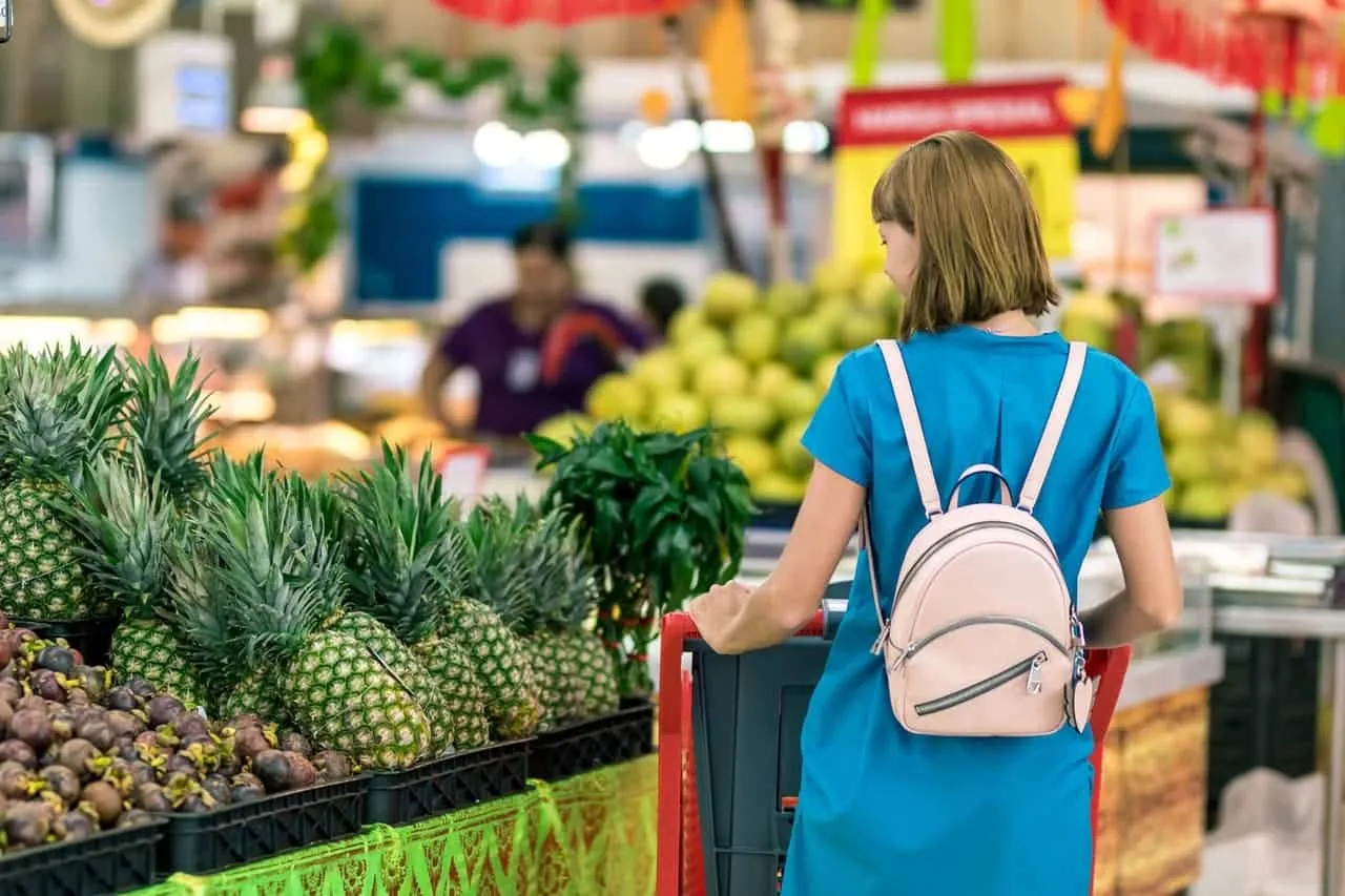 woman standing beside pineapple fruits 2292919 image