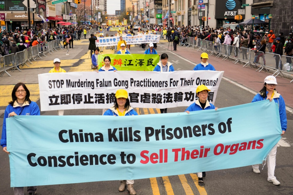 LBD8101 killing prisoners falun gong banner parade new york april 1200x800 1