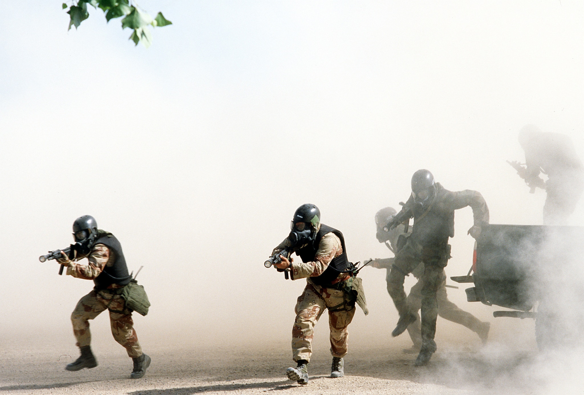 U.S. Navy Sea Air Land SEAL team members wearing chemical biological masks train in the Southern California desert DN ST 88 06287 scaled