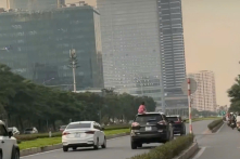 Để con gái ngồi trên nóc ô tô đang chạy, người mẹ bị phạt 5 triệu đồng